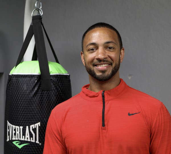 Ali Benjamin Smiling in a boxing gym