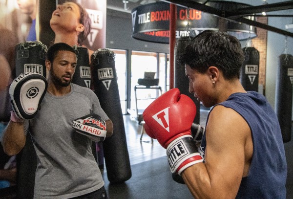 Ali Benjamin training a boxer