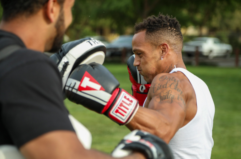 Ali Benjamin training a boxer